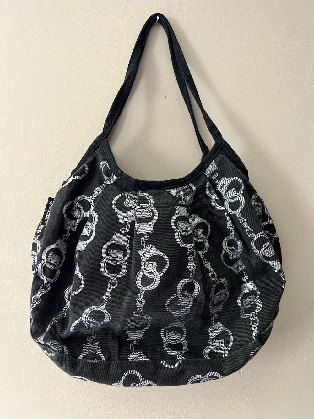 Vintage Yak-Pak shoulder bag in black denim with all over silver handcuff print.